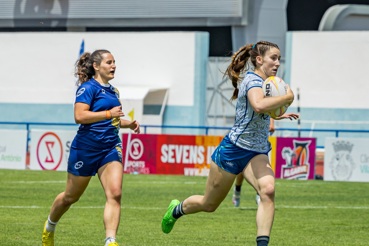 Women's sevens players sprinting clear during a match at the Algarve 7s